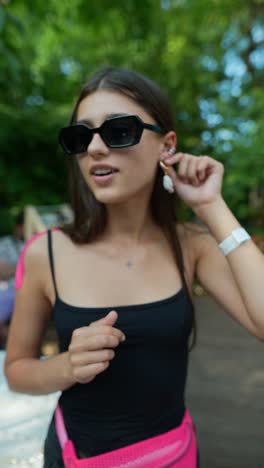 woman in sunglasses and earrings