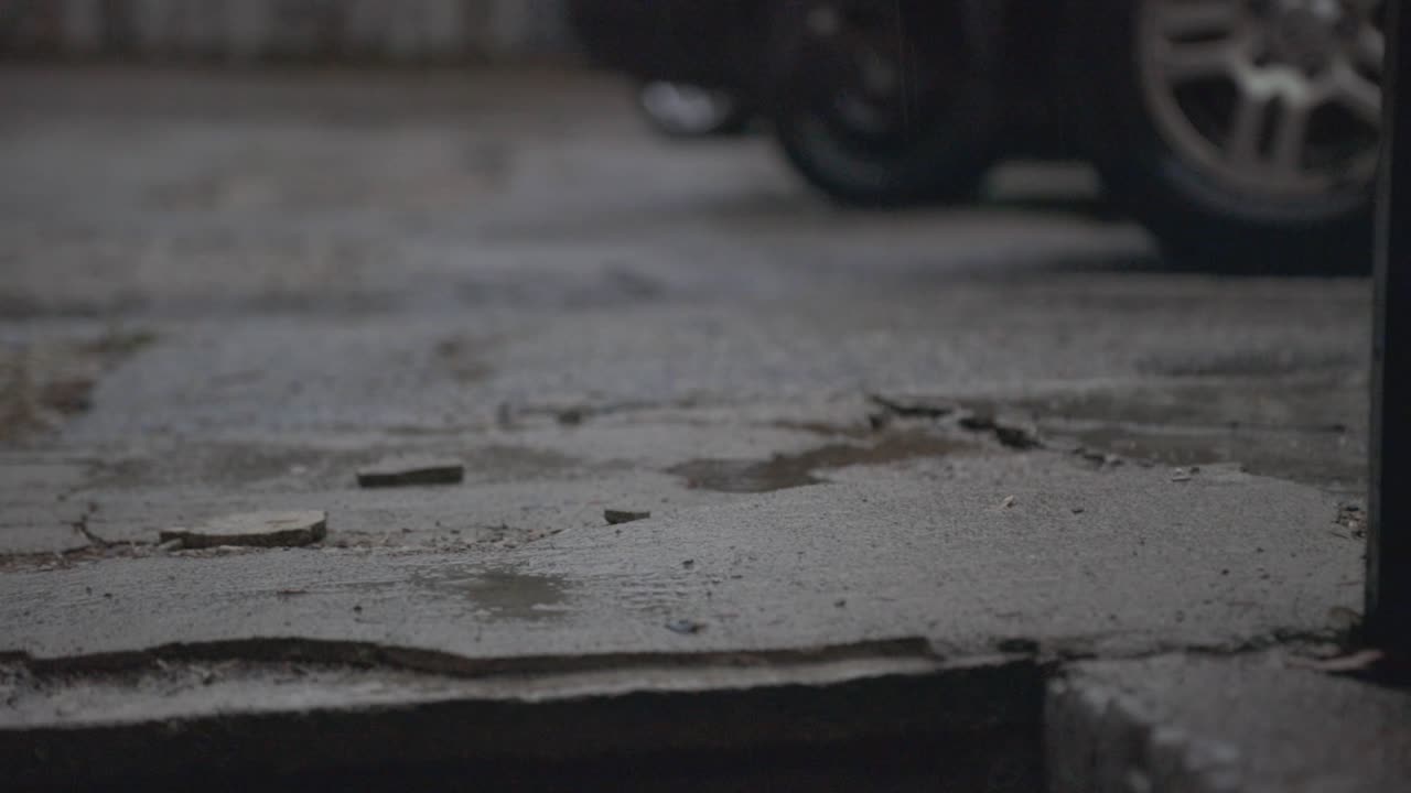Rain Falling On The Concrete Ground With Blurry Background On A Stormy Weather - Closeup Shot