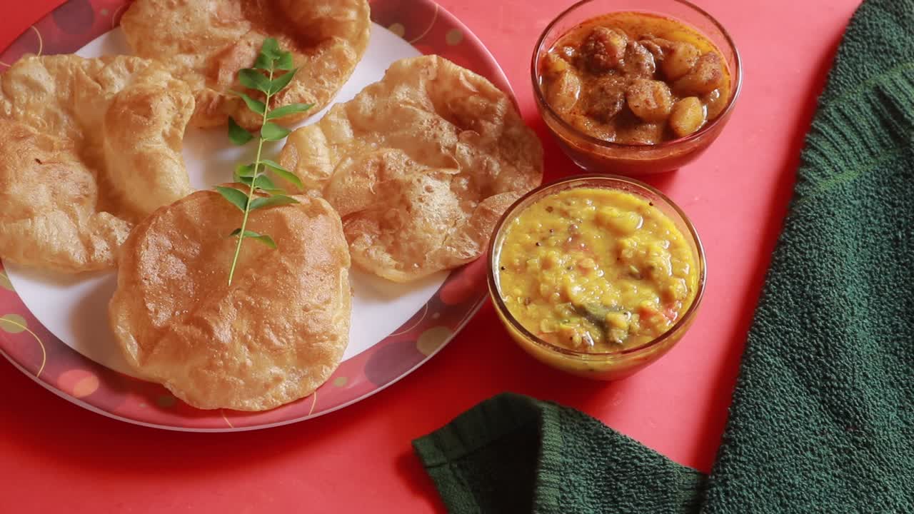 rotación chole bhature o curry de garbanzos y puri frito servido en vajilla de terracota sobre fondo