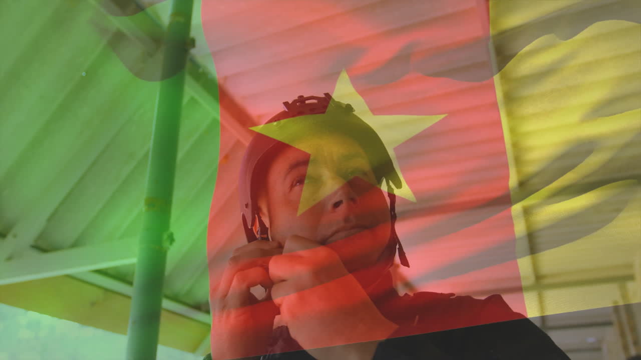 Wearing helmet with Cameroon flag, man in animation-themed outdoor environment