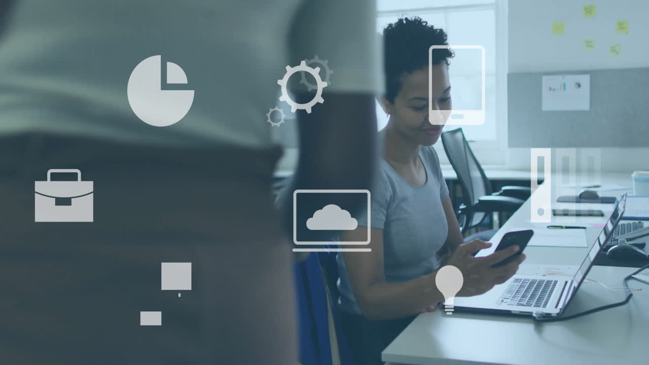 Business icons animation over woman using smartphone and laptop in office