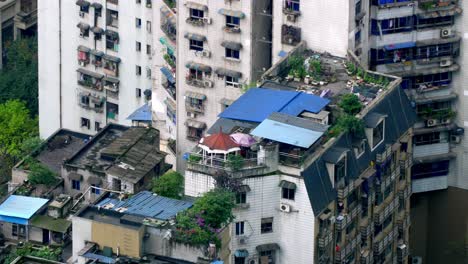 Chongqing-China,-Residential-building-rooftops-with-eco-gardens-are-seen-close-up-including-trees-and-a-gazebo,-Locked-establishing-zoomed-shot
