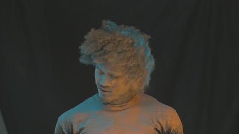 man in color powder explosion slow motion
