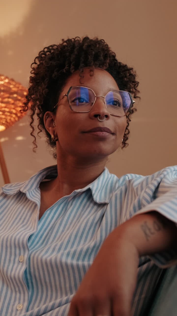 Thoughtful Woman Gazing Out Window in Cozy Apartment