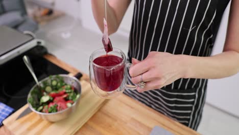 person making tea in a kitchen