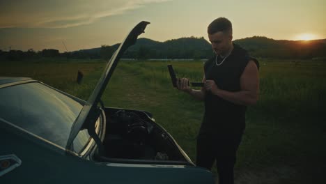 man preparing for a road trip in the countryside at sunset
