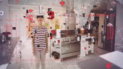 animation of data processing with digital icons over woman wearing vr headset in kitchen