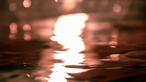 slow motion water waves background reflecting light during sunset or sunrise, ripple h2o background