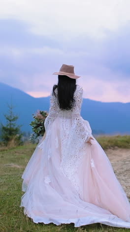Bride on mountain hill. Beautiful young bride walking on the mountain hills