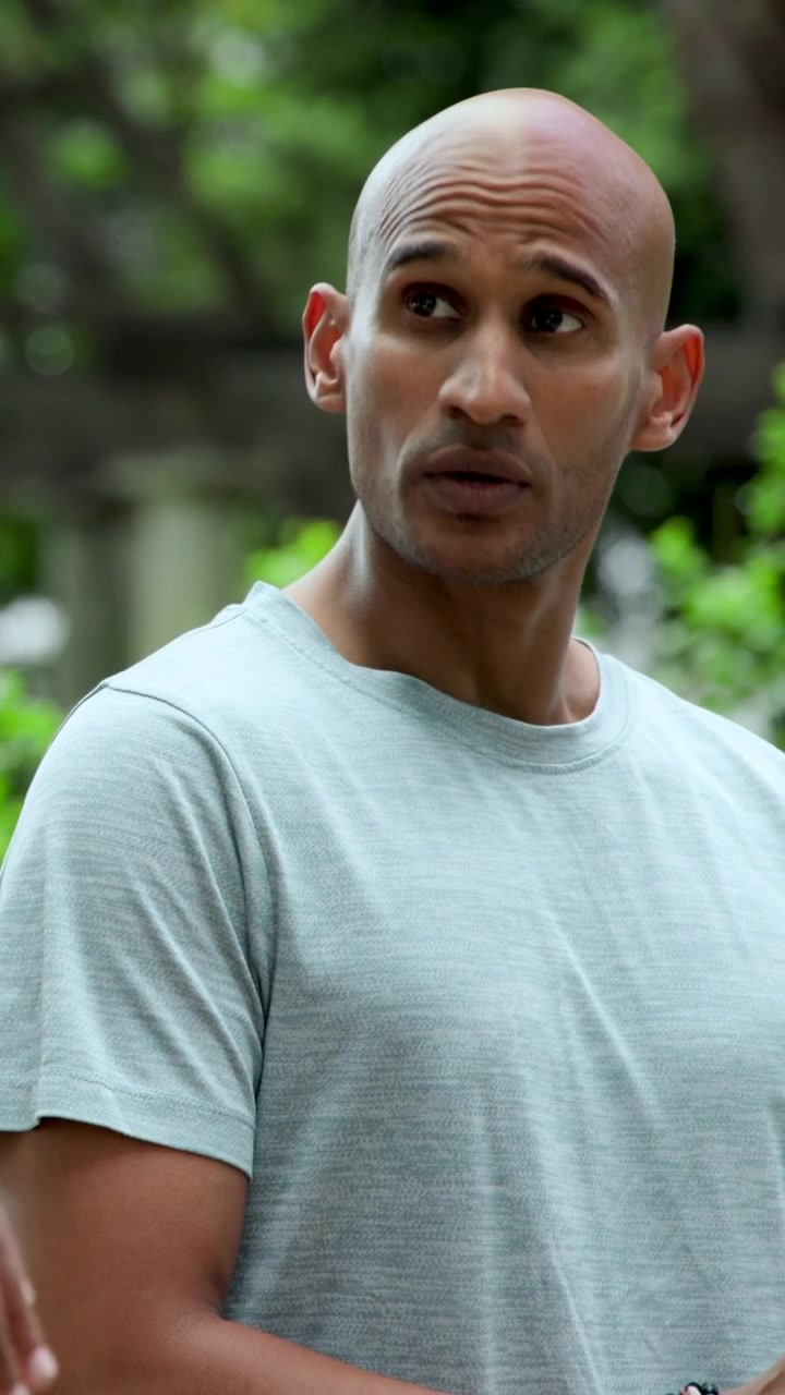 Vertical video: Shifting man in gray tee greeting incoming arm wearing white watch, exiting garden