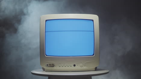 vintage television on a table with smoke
