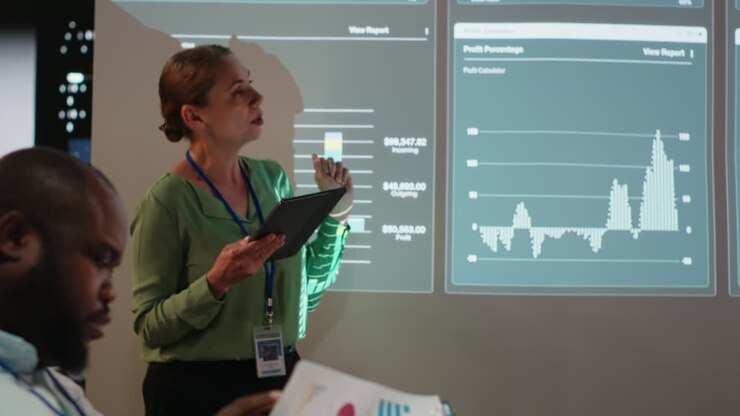 Business partners reviewing monthly data reports in night time meeting