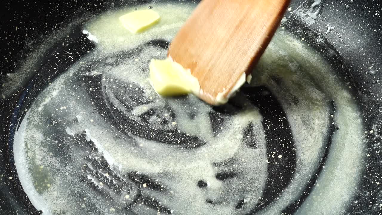 Butter on a frying pan with non-stick coating. Shooting in kitchen