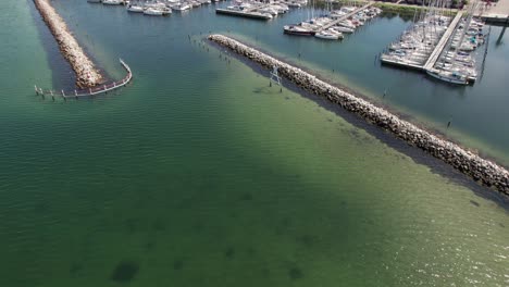 Birdseye-View-of-Small-Port-with-Vessels,-Sailing-Boats-and-Boats