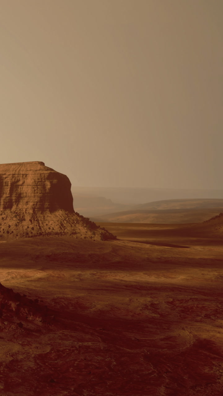 Mountainous landscape with rock formations and vast plains during sunset