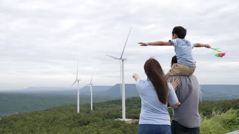 Concept-of-progressive-happy-family-enjoying-their-time-at-the-wind-turbine-farm