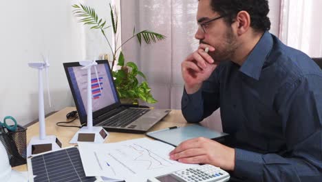 analyst documenting trends by writing on a line graph report
