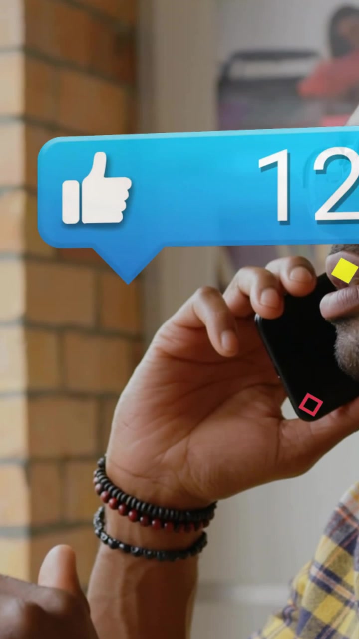 Vertical video: Man taking call at desk, animated bubbles floating over face tracking social counts