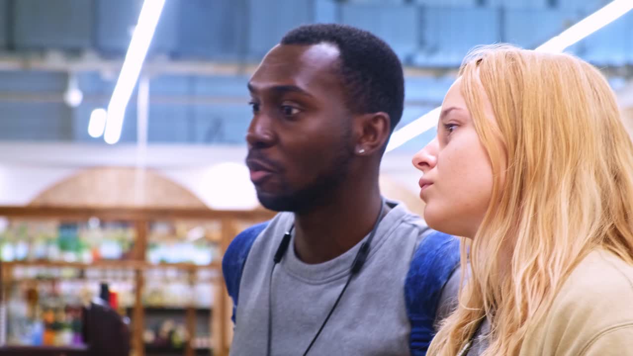 An Engaging Interaction Between Two Individuals in a Brightly Lit Store, Capturing Moments of Connection and Shared Focus in a Casual Setting