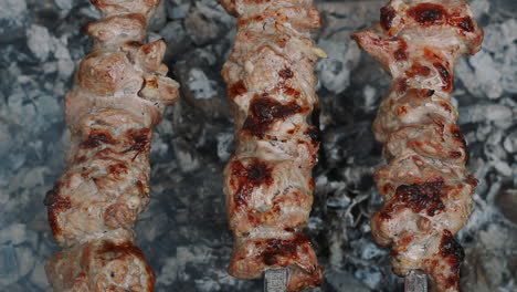 grilling meat bbq on smoking charcoal. close up meat barbecue on charcoal grill