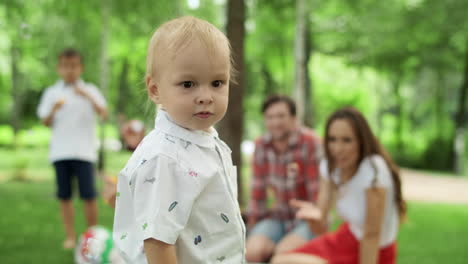 Toddler-looking-at-camera-with-family