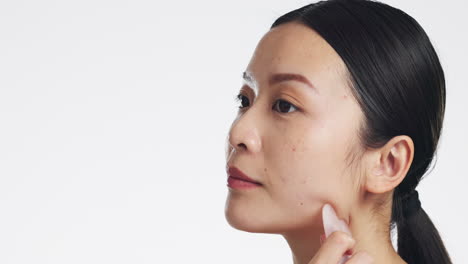 gua sha, skincare and woman massaging face