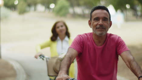 Vista-Frontal-Del-Hombre-Barbudo-Feliz-Sentado-En-Bicicleta