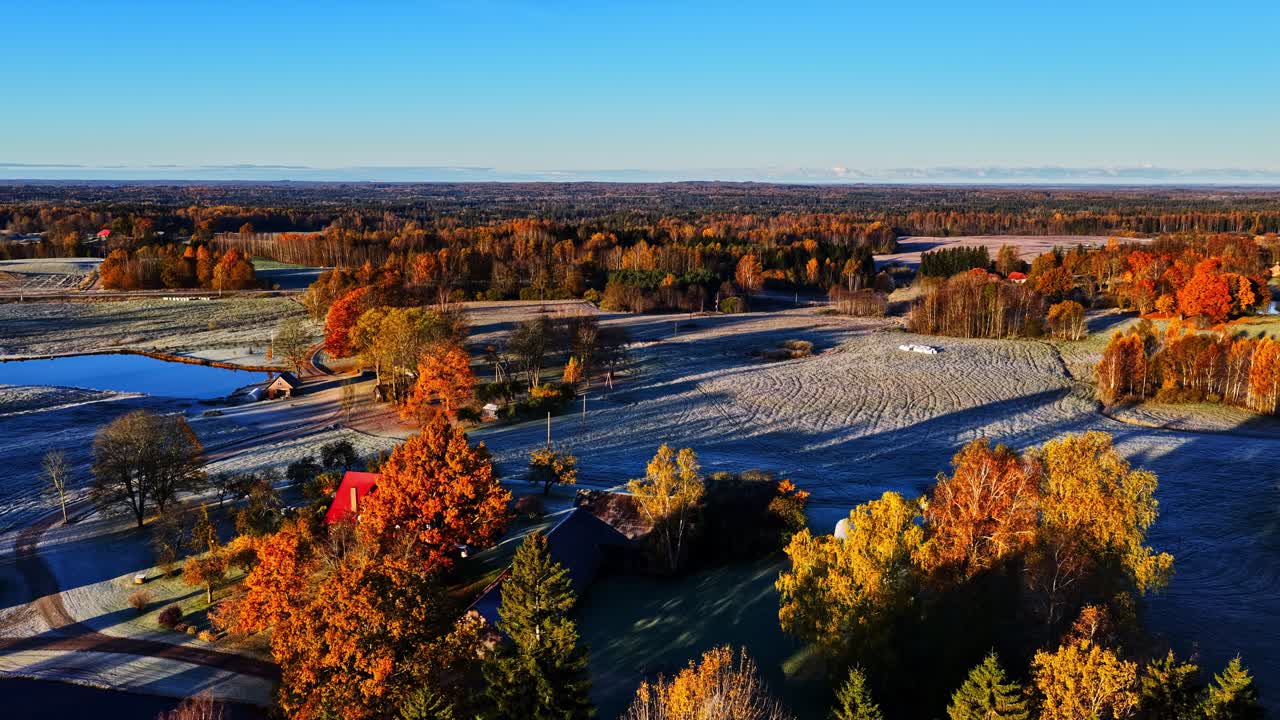 Colorful autumn landscape with frosty fields and vibrant foliage