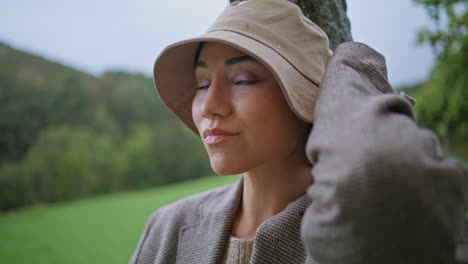 woman in a hat in a countryside setting