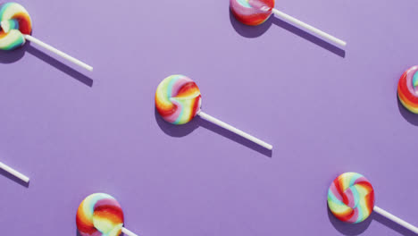 Video-of-rows-multicoloured-lollipops-on-blue-background