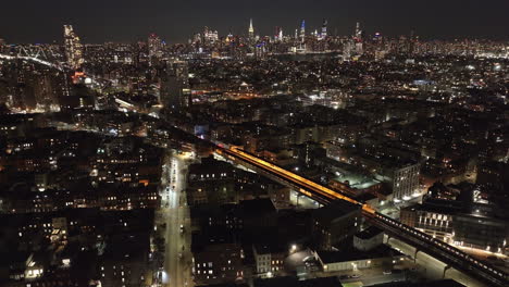 aerial view of the subway passing through brooklyn at night