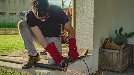 worker angle grinder cuts iron profile 5