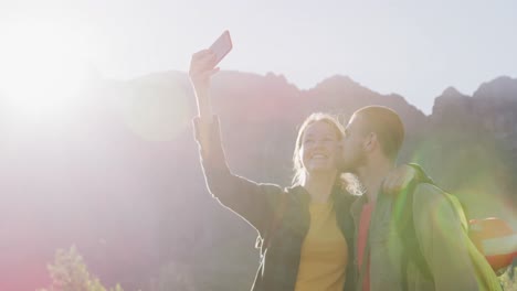 Caucasian-couple-taking-a-selfie-in-nature