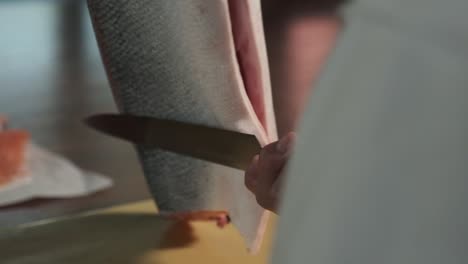 chef preparing fresh salmon in the kitchen