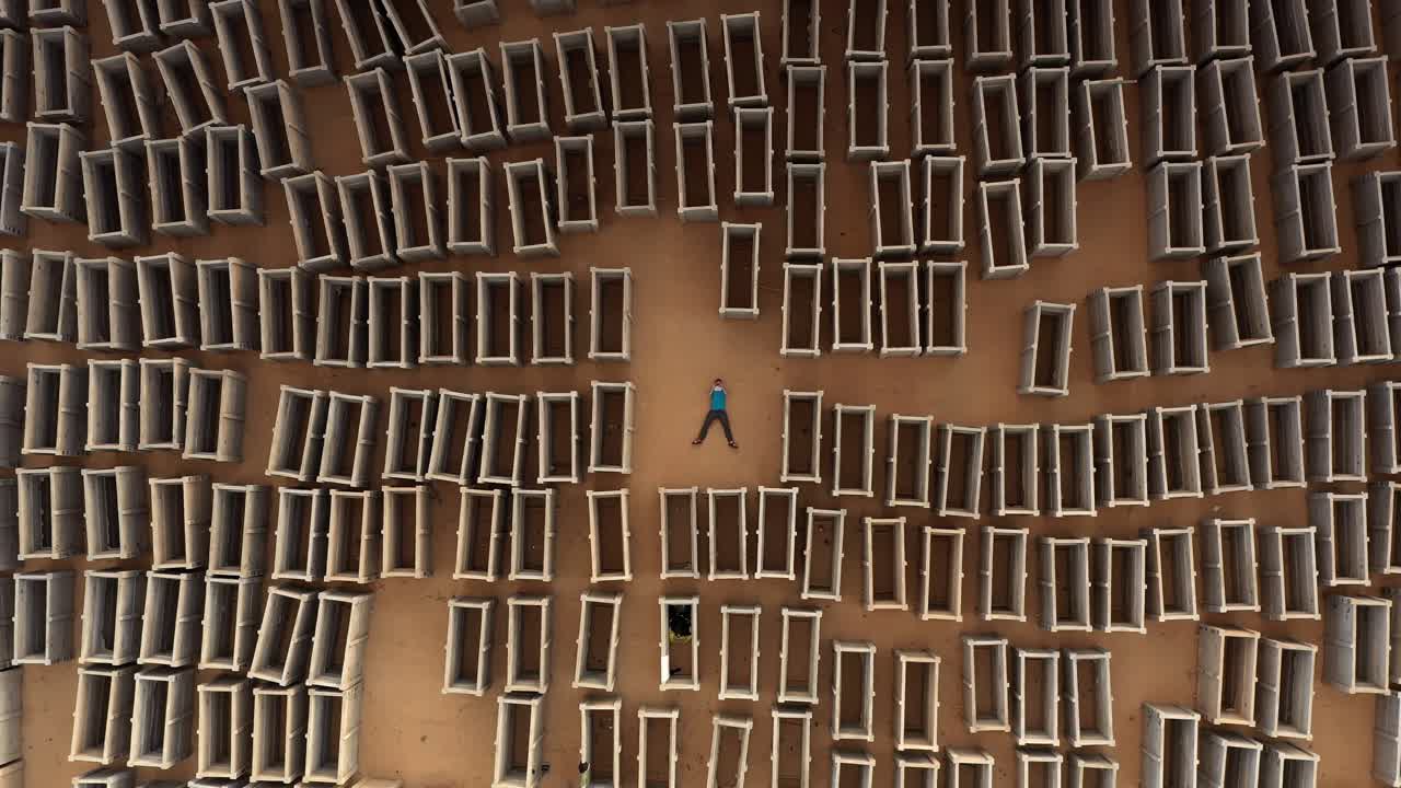 Person Lying Down Amongst Pre-cast Concrete Blocks