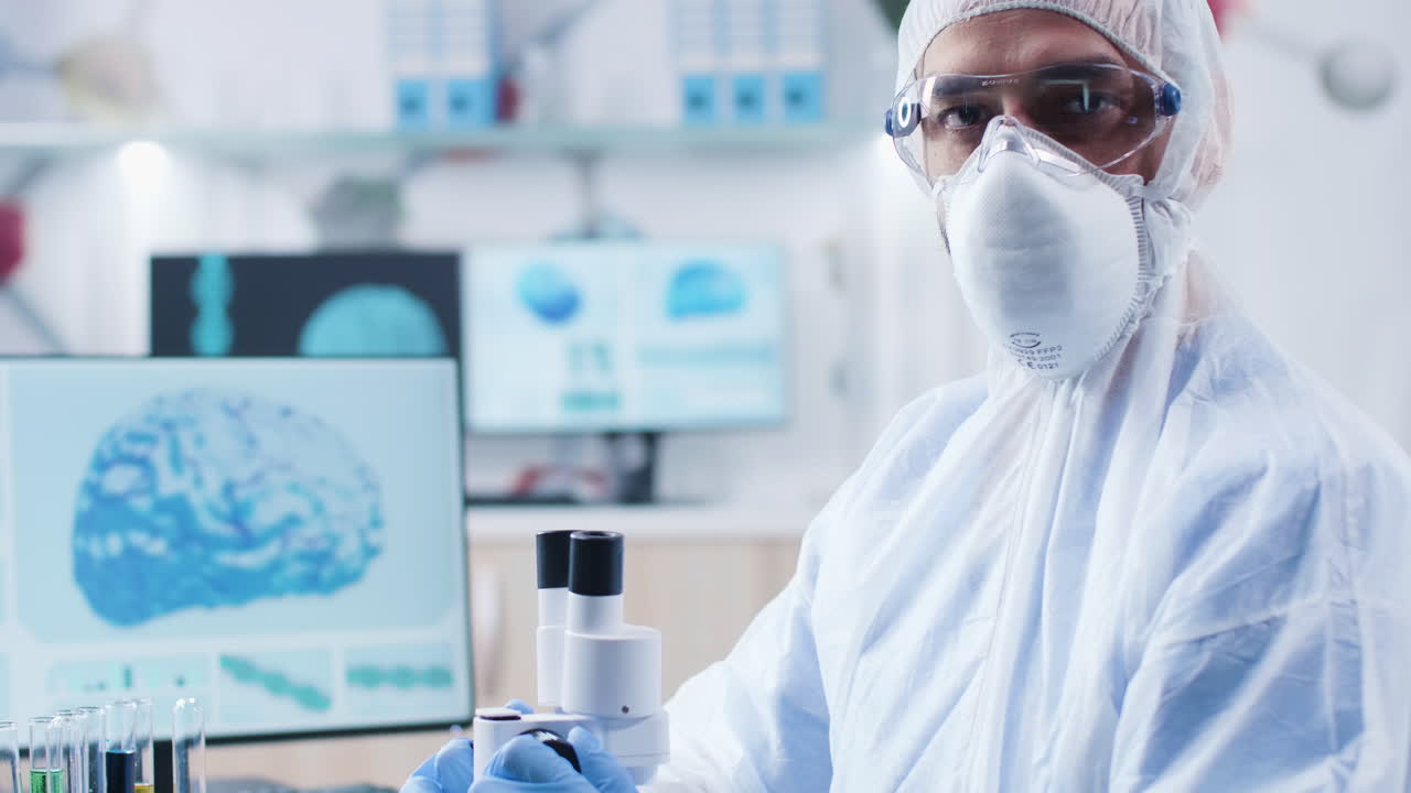 Scientist in Protective Gear Conducting Research in Lab