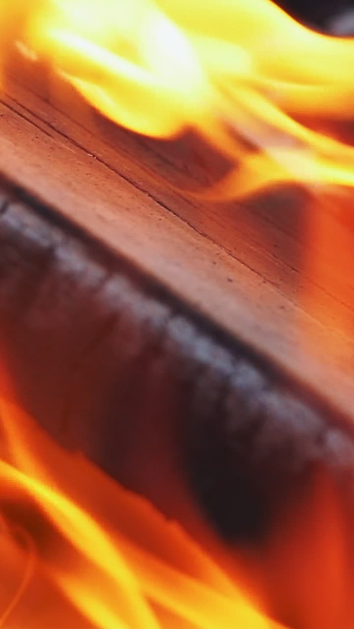 Burning Wood. Burning fire in a home fireplace. Slow motion Vertical video
