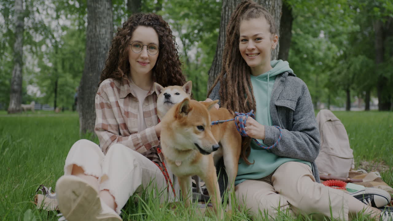 Two women and their dogs in a park