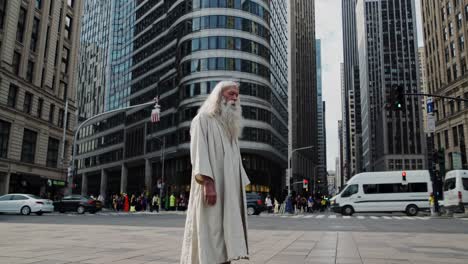 senior man with long white hair and beard, dressed in a flowing white tunic, walking through a bustling urban landscape filled with skyscrapers and busy traffic