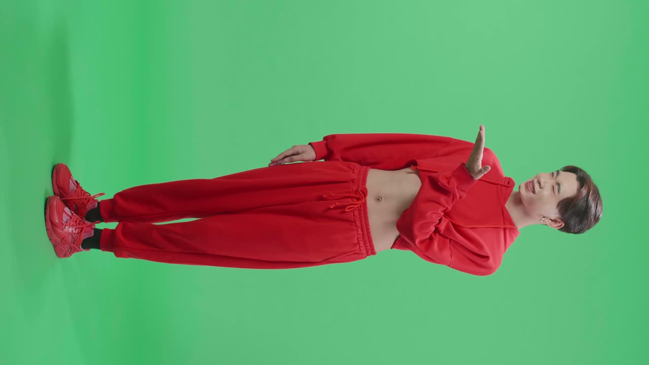 Man in Red Cropped Top and Sweatpants on Green Screen