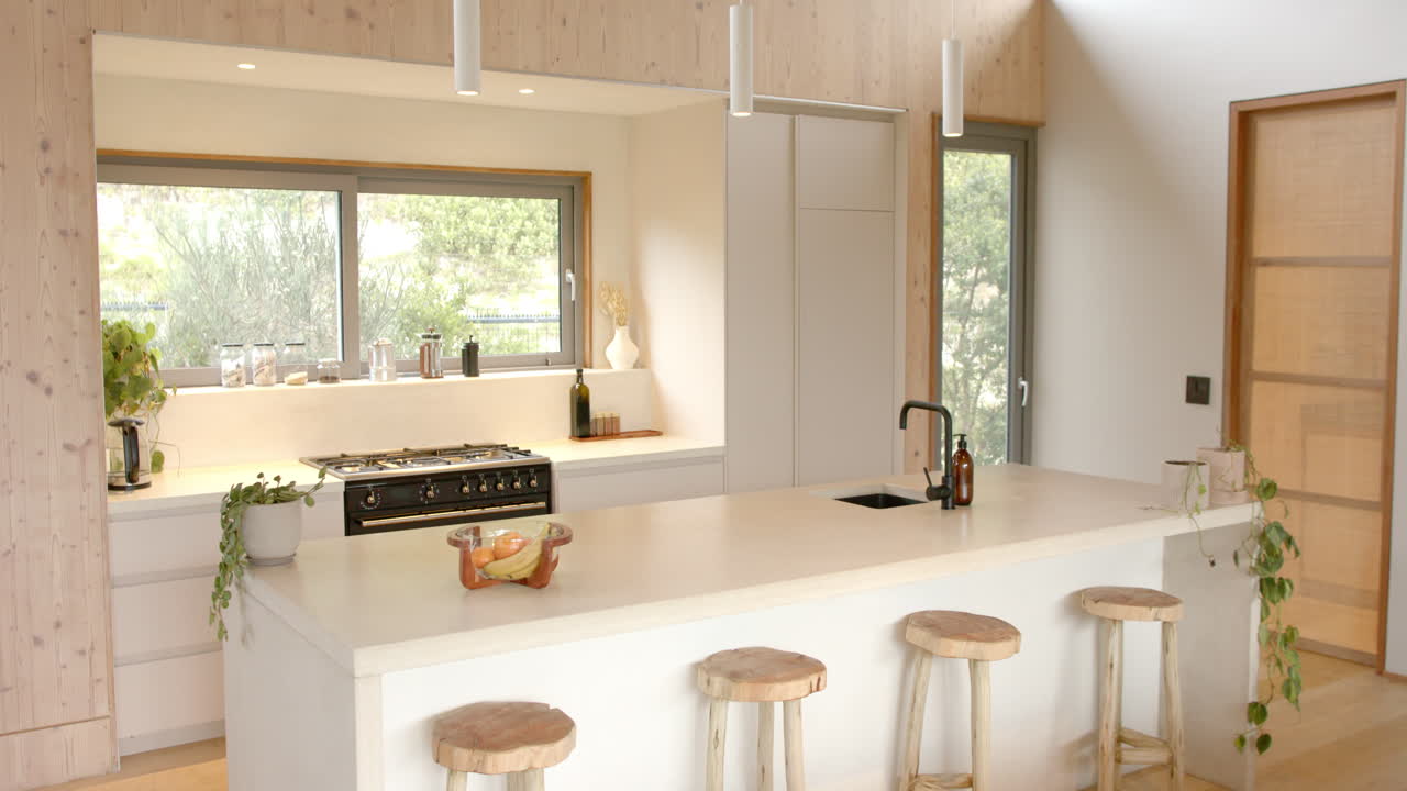 Modern kitchen with wooden stools and plants, creating cozy holiday atmosphere, copy space