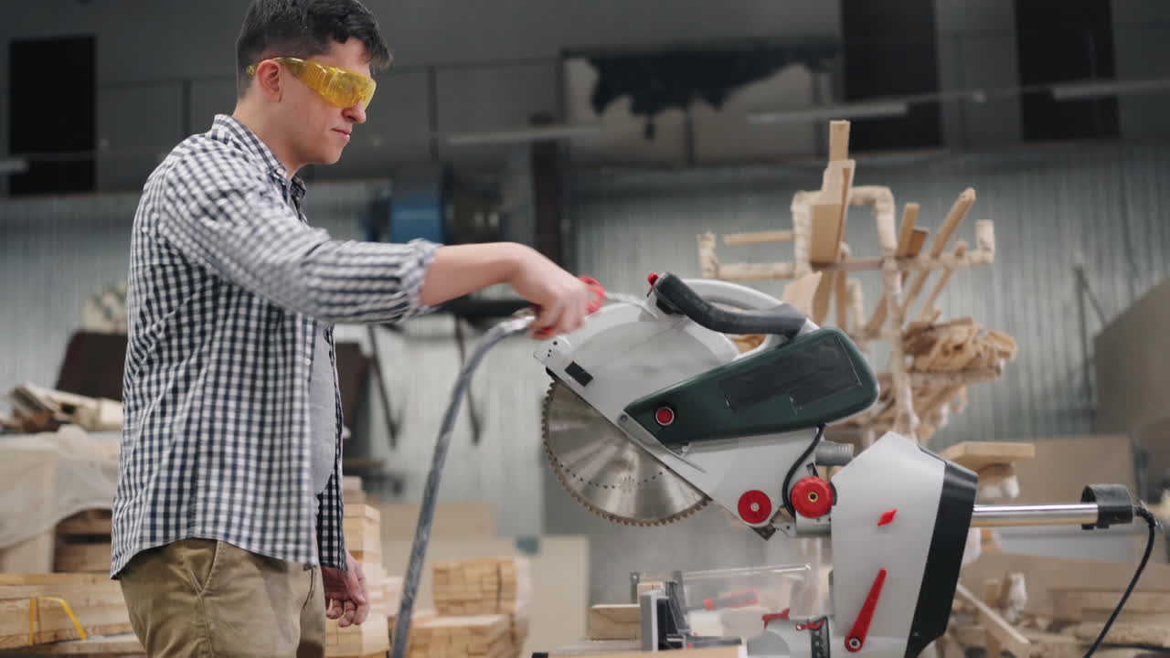 Carpenter using a circular saw in a workshop