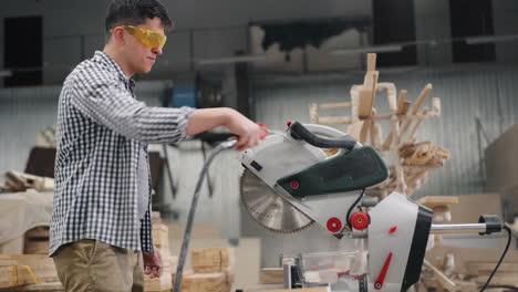 carpenter using a circular saw in a workshop