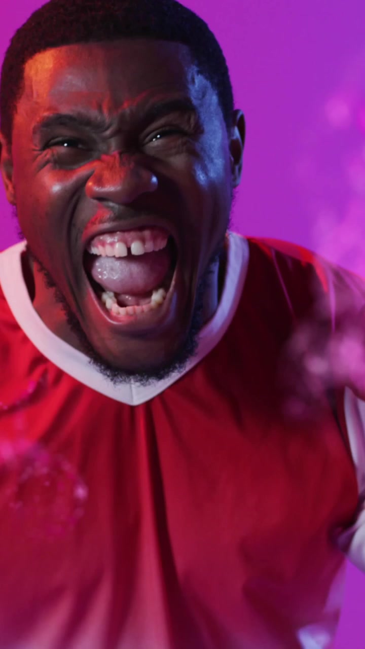 Animation of african american male soccer player over shapes