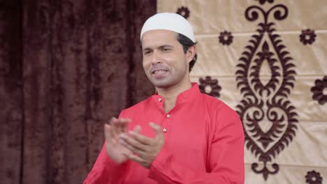 proud muslim man clapping and smiling