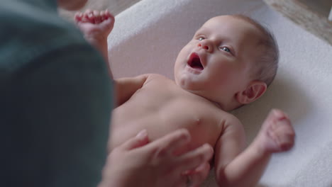 young mother kissing happy baby laughing enjoying loving mom nurturing toddler at home