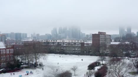 rising aerial drone shot city of london snow day january