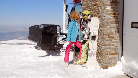 Couple-kissing-behind-ski-resort-garage