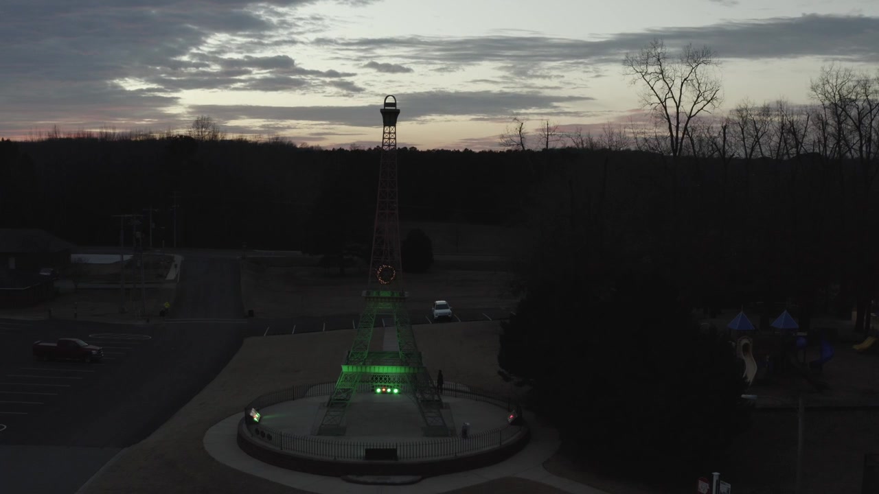 Drone footage of beautiful Eiffel Tower Park in Paris Tn at sunset.