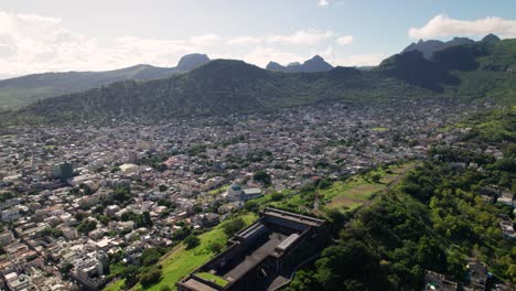 Citadel-fort-adelaide-in-port-louis,-mauritius,-with-cityscape-and-mountains,-aerial-view